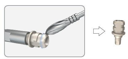 A carbide or acrylic bur cutting the abutment held on the analog, with an arrow to the shaped temporary abutment.